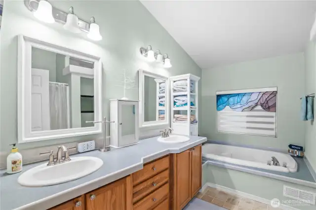 Updated bathroom with double sinks and large soaking tub.