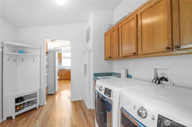 You will LOVE this convenient laundry room with door to carport. Features lots of cabinets and storage area along with utility sink and REAL wood flooring.