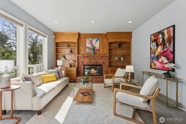 Family room with gas fireplace and built-ins looks out to back yard.