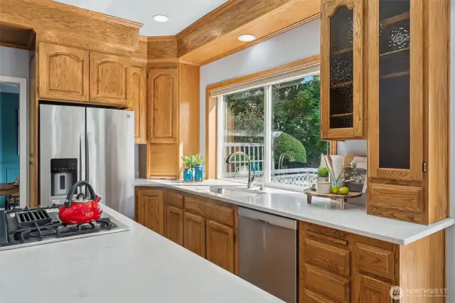 Large island and kitchen overlooks the back yard