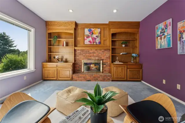 Extra room with gas fireplace and built-in off of the primary suite