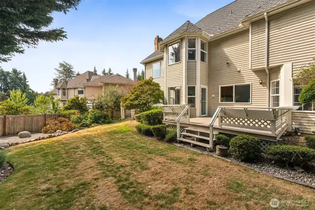 Deck off of the kitchen and eating nook looks out to what will soon be your own lush landscape