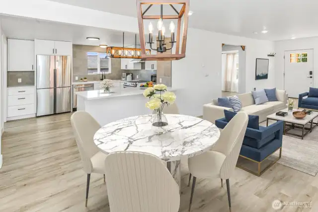 Virtually staged. Dining room with a view of the updated kitchen
