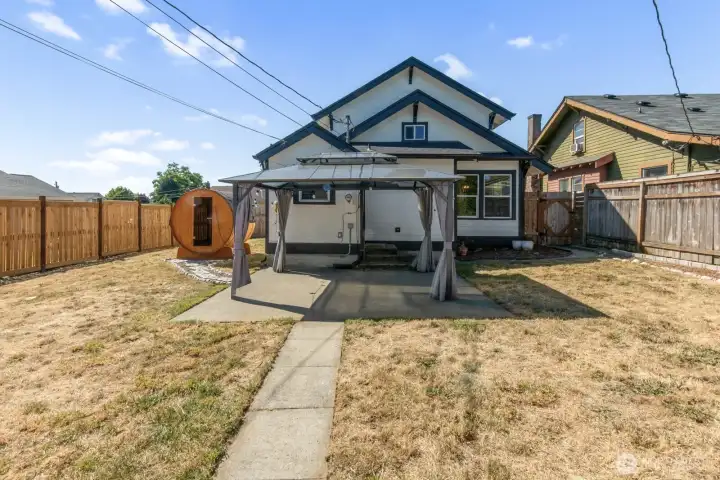 View of the back of the home with a gazebo.