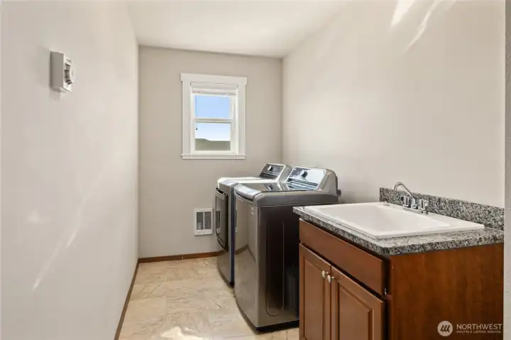 Upper level laundry room w/utility sink + storage