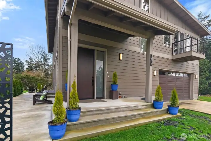 Attractive covered front entrance and side patio.