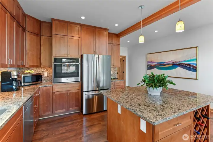 A cooks delight with stainless and granite. Note the granite climbs the wall to under the cabinets and the cabinets reach the ceiling for lots of storage.