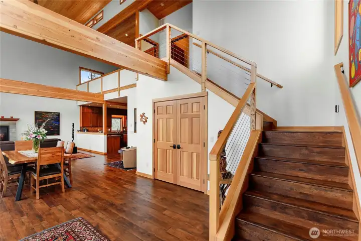 Stairs to the upper level of the house. Gorgeous exposed beams and wood work.