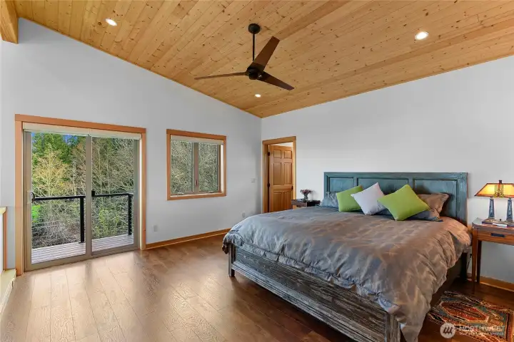 Upstair primary bedroom with a deck off the side.