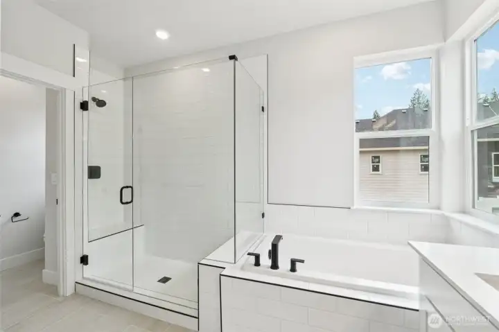 Soaking tub, frameless shower, extensive tile on floor and shower.