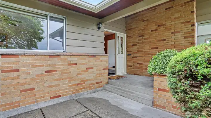 Inviting entry with mid-century modern brick.