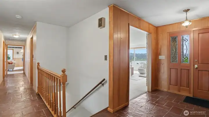 From the entryway you have access to the living room, downstairs basement, and hall leading to the family room and kitchen.