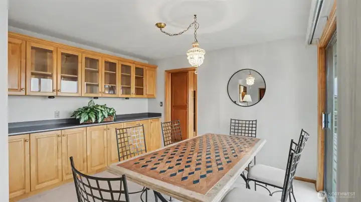 Dining area with custom built ins and access to the outdoor deck on the front of the house.