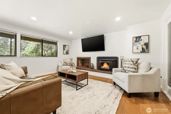 recreational room with a fireplace insert