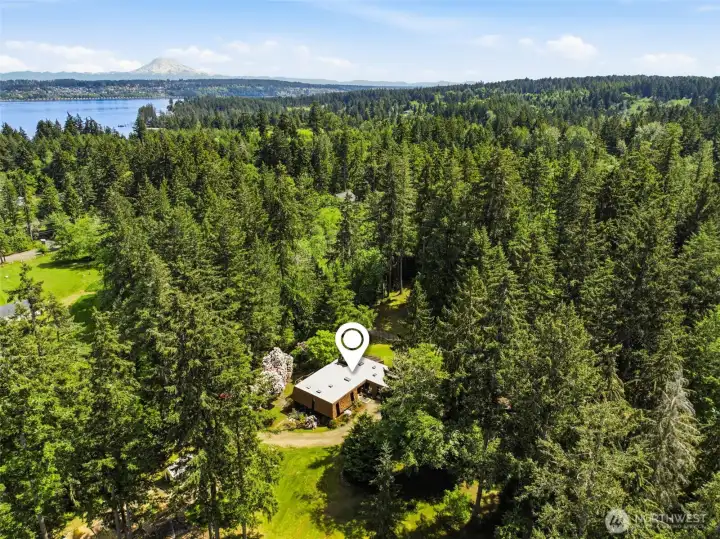 surrounded by lush evergreens plus beautiful trails throughout the property