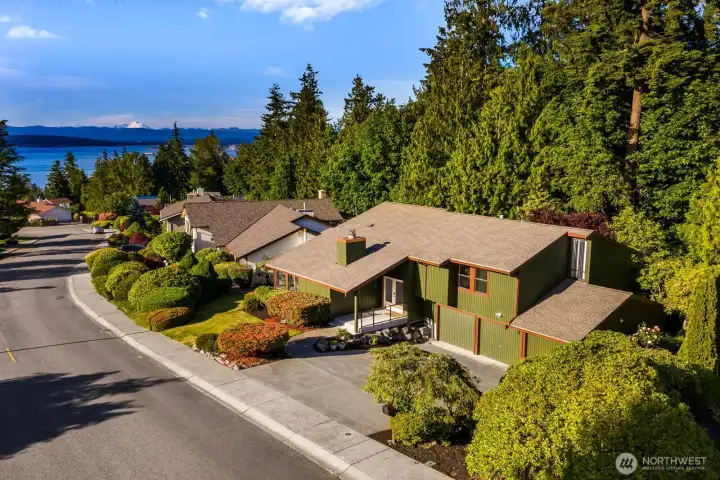 Tucked away neatly into the trees, surrounded by mature landscaping.  The home enjoys all day sunshine and amazing sunsets into the mountains