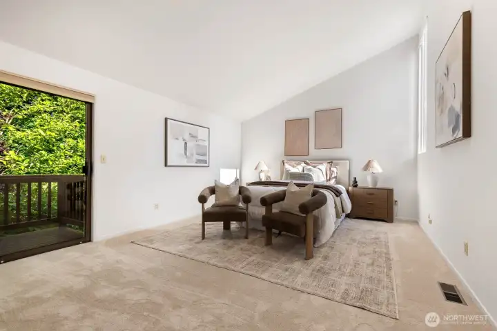 Primary Bedroom down the hall, has it's own deck overlooking the backyard