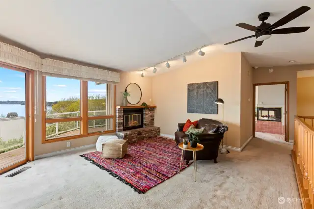 Second level family room with fireplace and sliding doors to more views of the water.