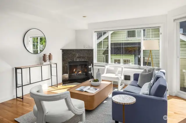 This light & bright living area centers around the gas fireplace.