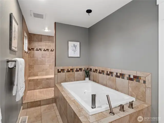 Indulge in relaxation in this beautifully appointed bathroom, featuring a deep soaking tub, perfect for unwinding after a long day.