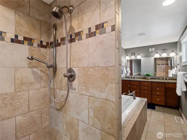 Featuring both a rain-style showerhead and a convenient handheld sprayer, this area provides a spa-like experience.