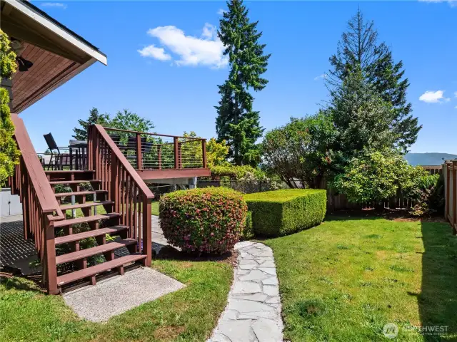 This property boasts a beautifully designed backyard, offering diverse outdoor living spaces.