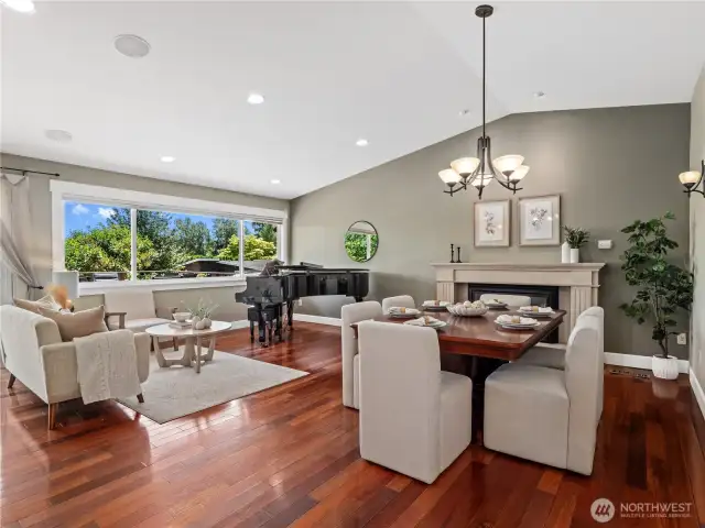 The expansive living and dining areas, bathed in natural light from large windows and recessed lighting, creating an inviting ambiance.