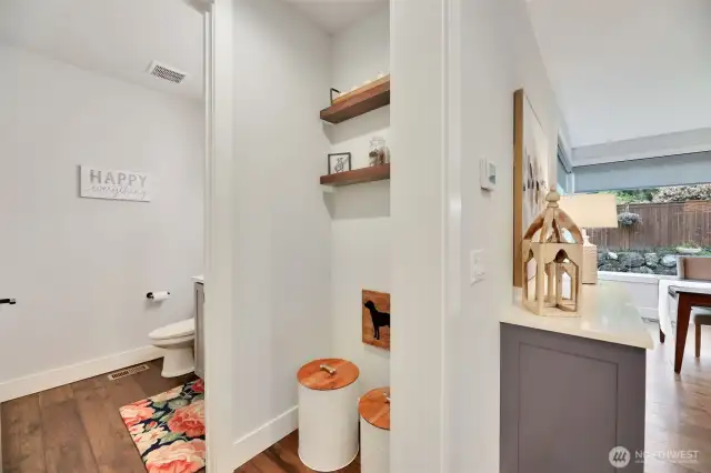A main level power room, set back from the family room. The additional flex space can also make for additional storage, or even add a temp controlled wine closet!