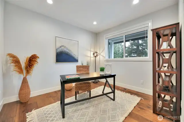 Through French doors just off the entry, a spacious executive office unfolds, bathed in natural light and designed for both functionality and versatility. This refined space offers an ideal setting for work-from-home productivity, while its generous layout makes it equally suited for a homework station, playroom, hobby area, or even an additional bedroom.