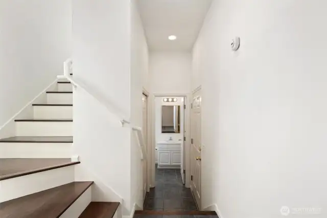 Entry with hallway to first level bathroom and stairs to main living area