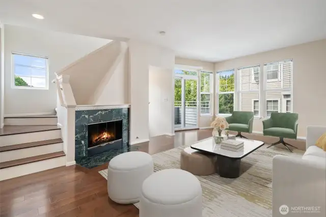 Open area living room with stairs to 1/2 bathroom & up to second level bedrooms & baths. Virtually staged.