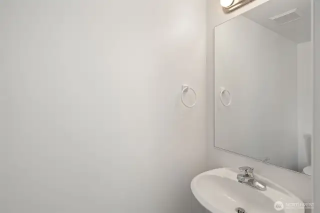 Main level bathroom with sink & toilet - new lighting and fixtures plus all fresh paint!