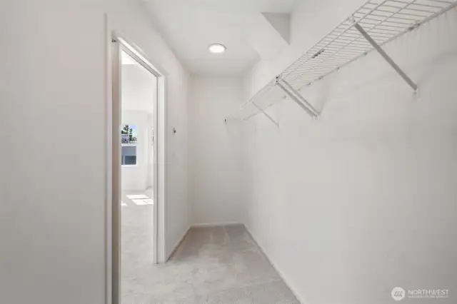Nice fresh primary bedroom walk in closet - new paint and carpets!