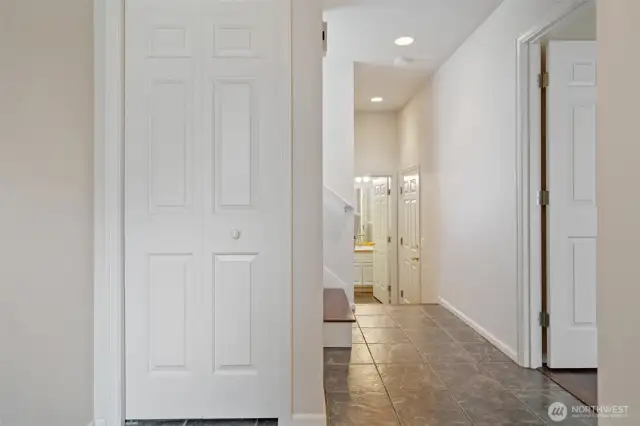 Entry with wood floors - bedroom or office off to the right, full bath & garage at the halls end