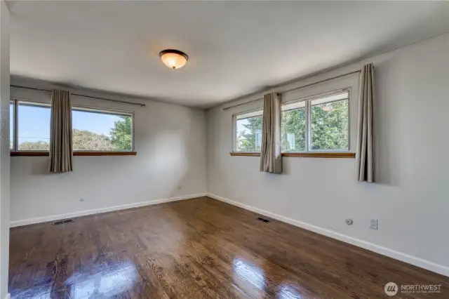 This angle in the primary suite shows the large windows that the room offers that bring a lot of the outside in.