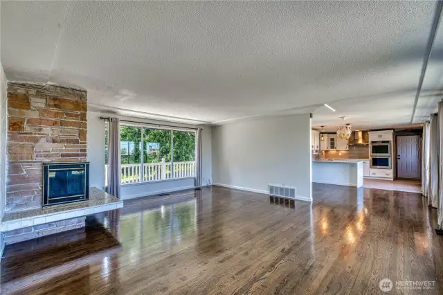 View from the entry, look at the gorgeous flooring and seeing the wall of windows on the back of the home that look out on to the beautiful, park-like backyard.  You also see the tastefully updated kitchen