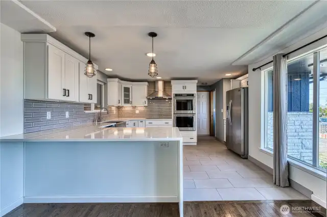 This is a GREAT isolated picture of the modernized and updated kitchen.  Sparkling hard surfaces, stainless appliances and lots of bright white cabinetry