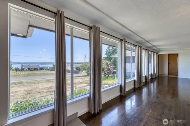 Check out he gorgeous flooring and the spectacular wall of windows that bring the outside in and offer beautiful views of the Sound and Mountains.