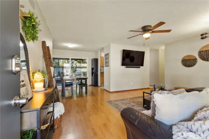 Enter into the combo Living/Dining Area where you'll enjoy laminate flooring, and a view to the back through the oversize slider.