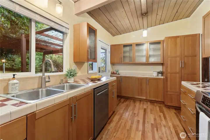 Tiled counter, newer maple cabinets, wood flooring