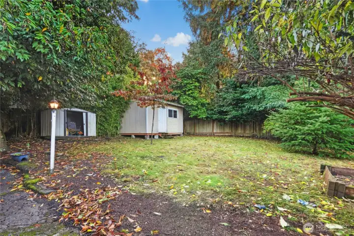 Large and private backyard with 2 storage areas, garden beds