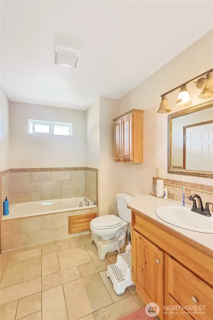 Bathroom on main floor with access off of the living space and off of the second bedrooom.