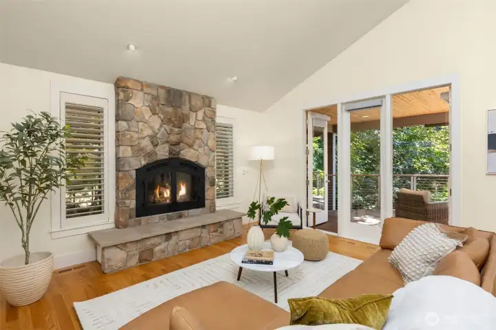 Main level great room with cathedral ceilings, skylights, and full-lite door leading to the spacious back deck.