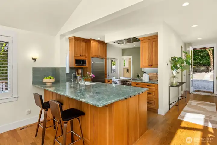 Wonderful kitchen set up with all the goods! A granite slab countertop and bar seating for 2 invite conversations while cooking meals.