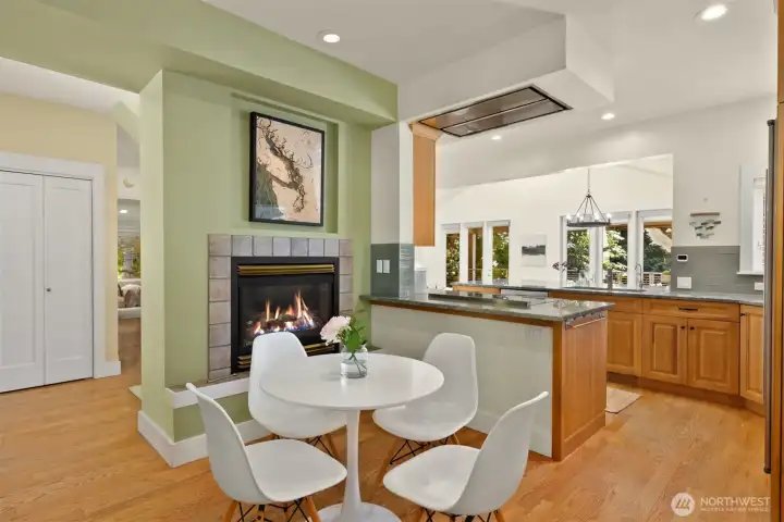 Dining nook right off the kitchen warmed up by a gas fireplace.