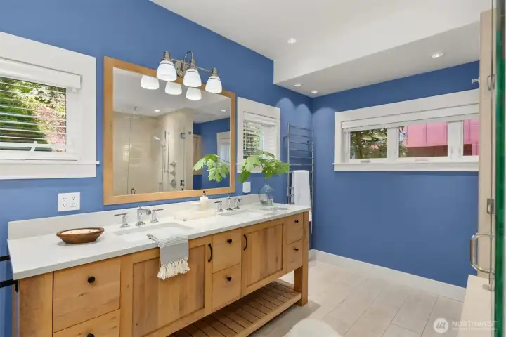 Primary bath, plenty of room to move around, complete with dual sinks and a towel warmer.