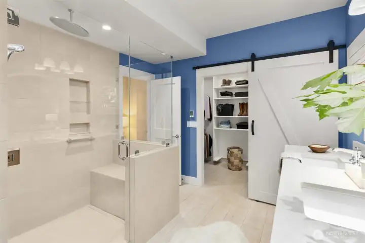 The stylish en-suite bath offers a walk-in shower with an oversized rain shower head for a spa-like experience, plus radiant heated floors.