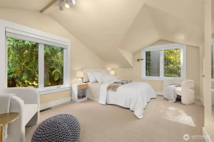 Second bedroom upstairs offer natural light and views of the lush greenery all around.