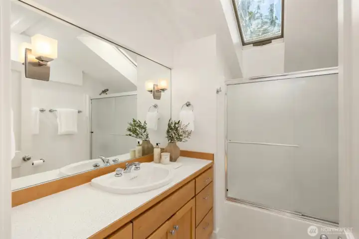 Upper level full bath complete with skylight.