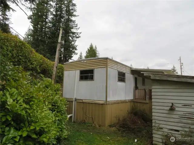 Back of the home, side deck and shed.